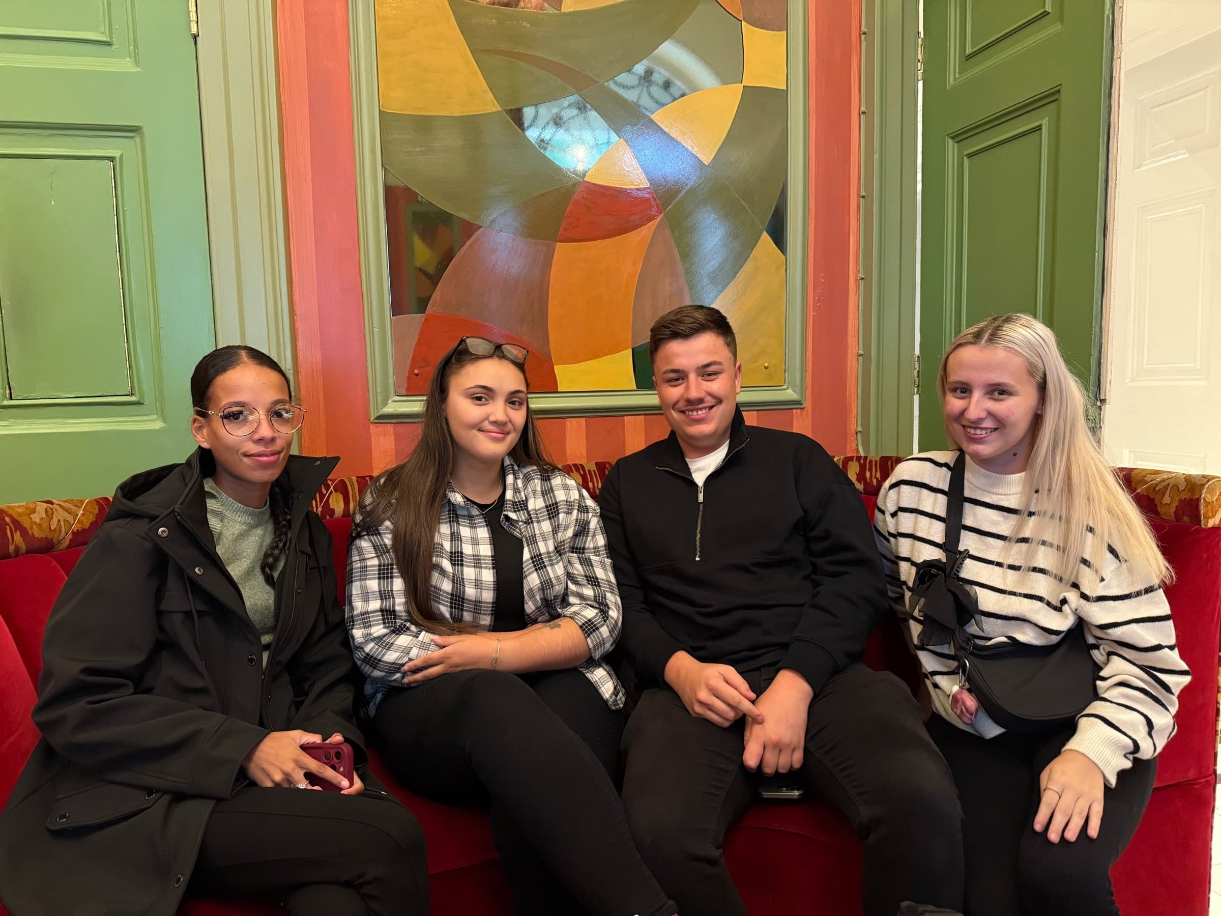 Four LENs Experts by Experience sitting together on a sofa.
